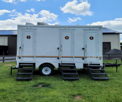 Toilet rental service truck in New York and purple porta potty Toilet rental service truck in New York and purple porta potty