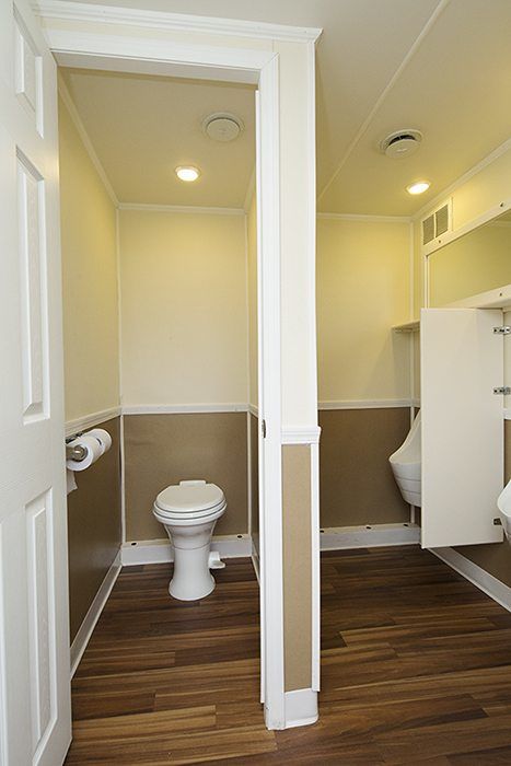 Full view of five station restroom trailer with two separate doors for men and women