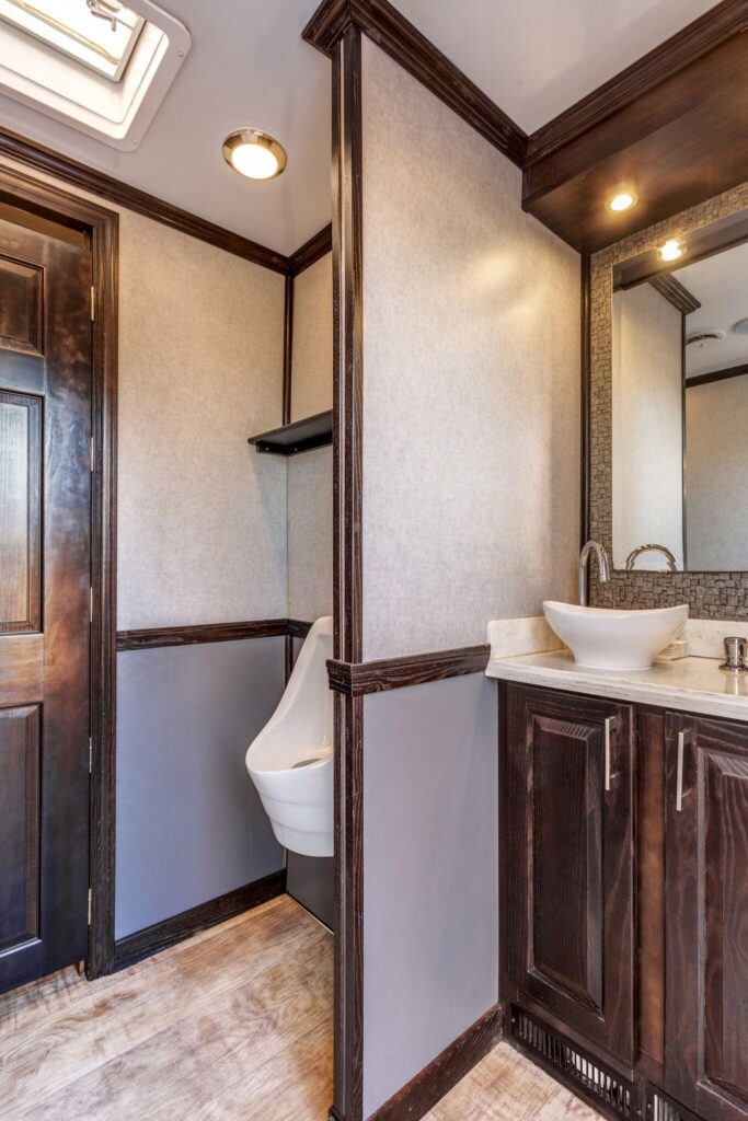Urinal and sink in restroom trailer rental in Texas Urinal and sink in restroom trailer rental