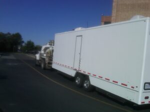 Delivering portable restrooms trailers