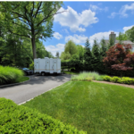 Restroom trailer surrounded by greenery and trees in New Hampshire