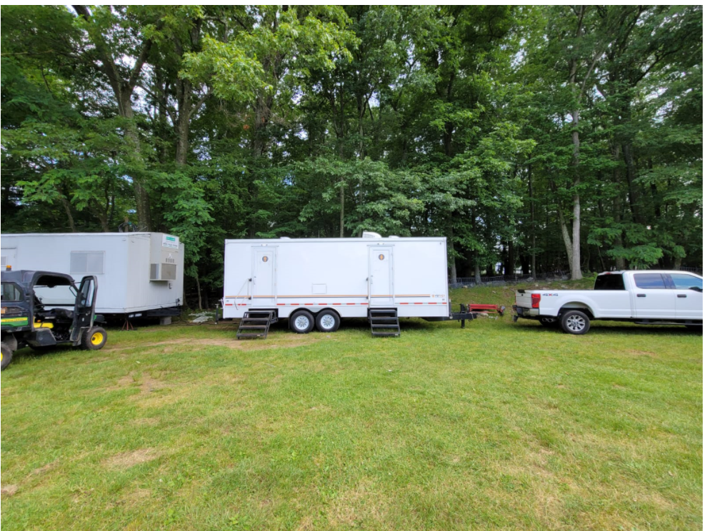 Setting up restroom trailers in open area