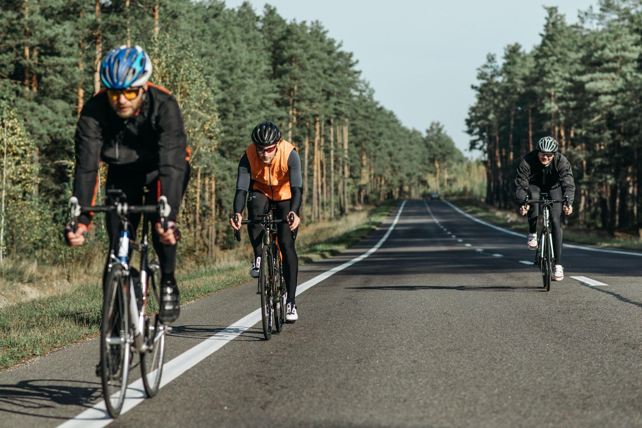 3 bikers riding on empty road 3 bikers riding on empty road