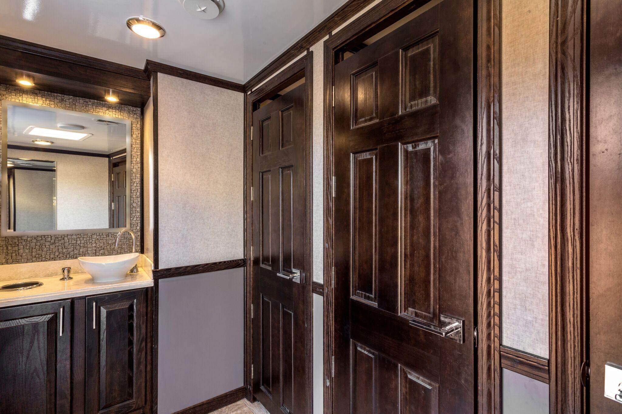 interior of bathroom trailer with sleek wood design