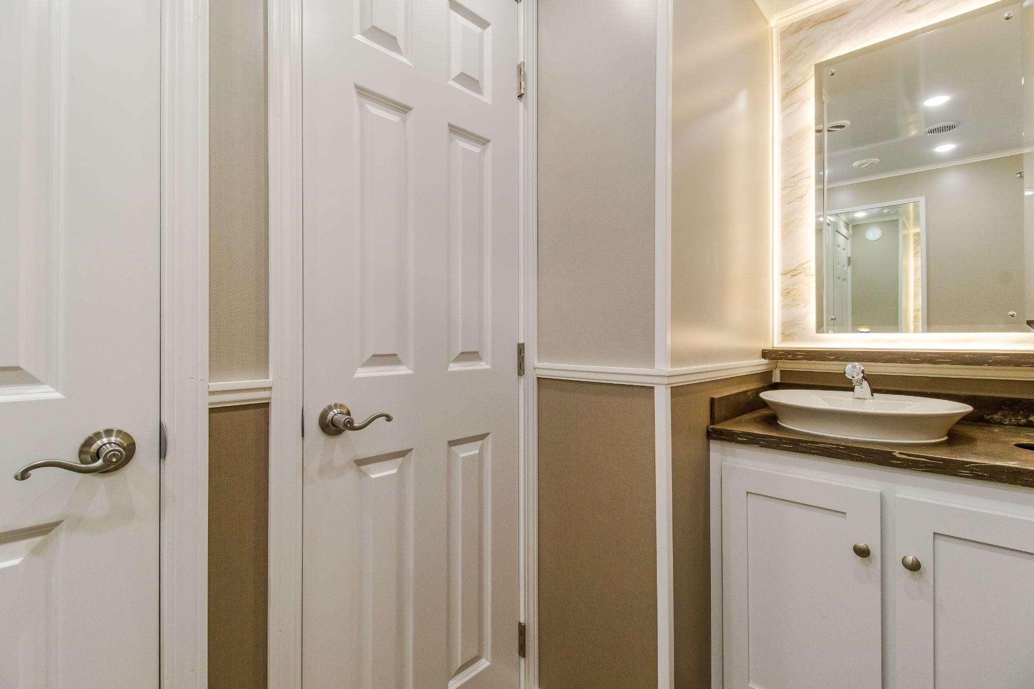 interior of mobile restroom trailer with lighter color design