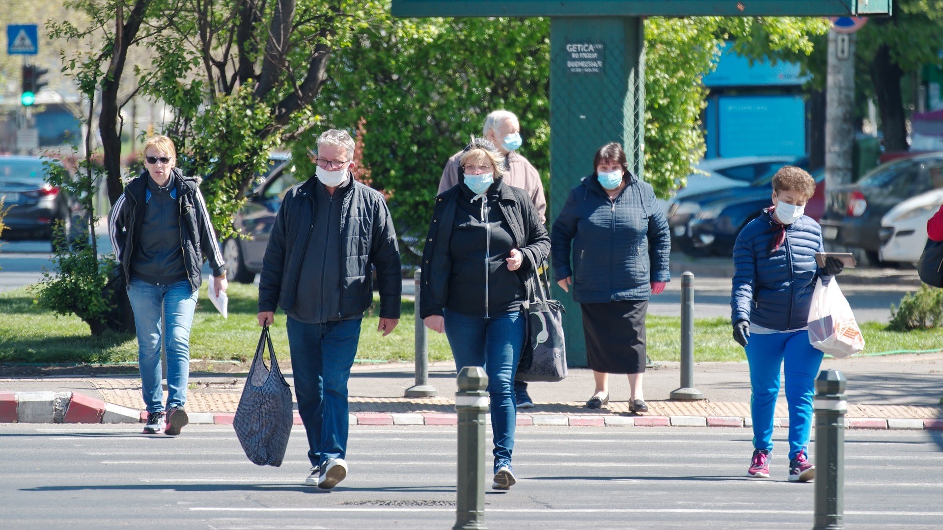 Seniors walking at a distance and wearing masks