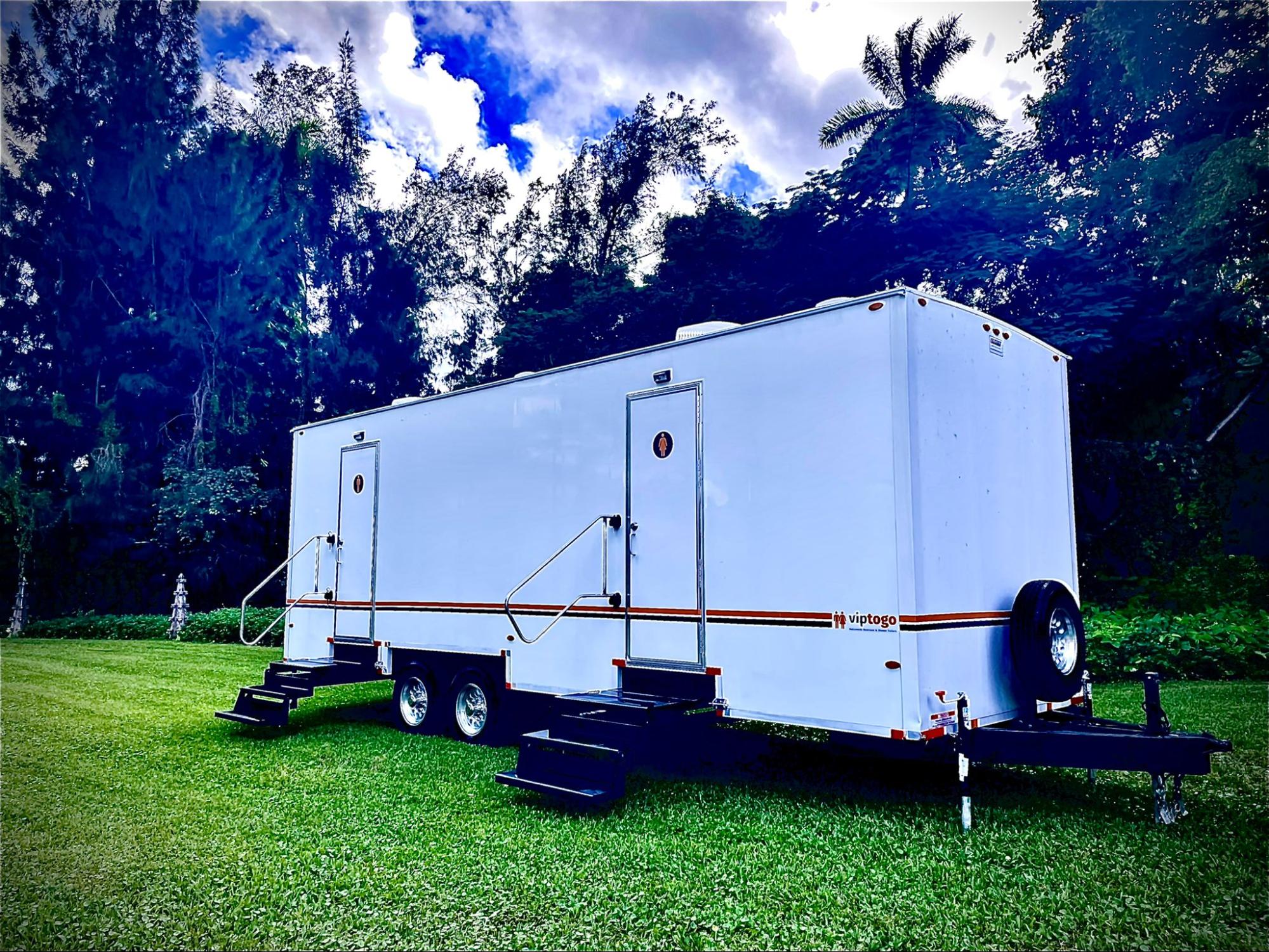 outdoor restroom parked on grass