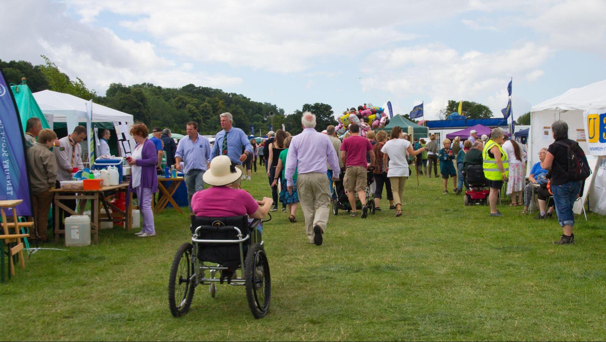 outdoor event space with handicapped person among guests