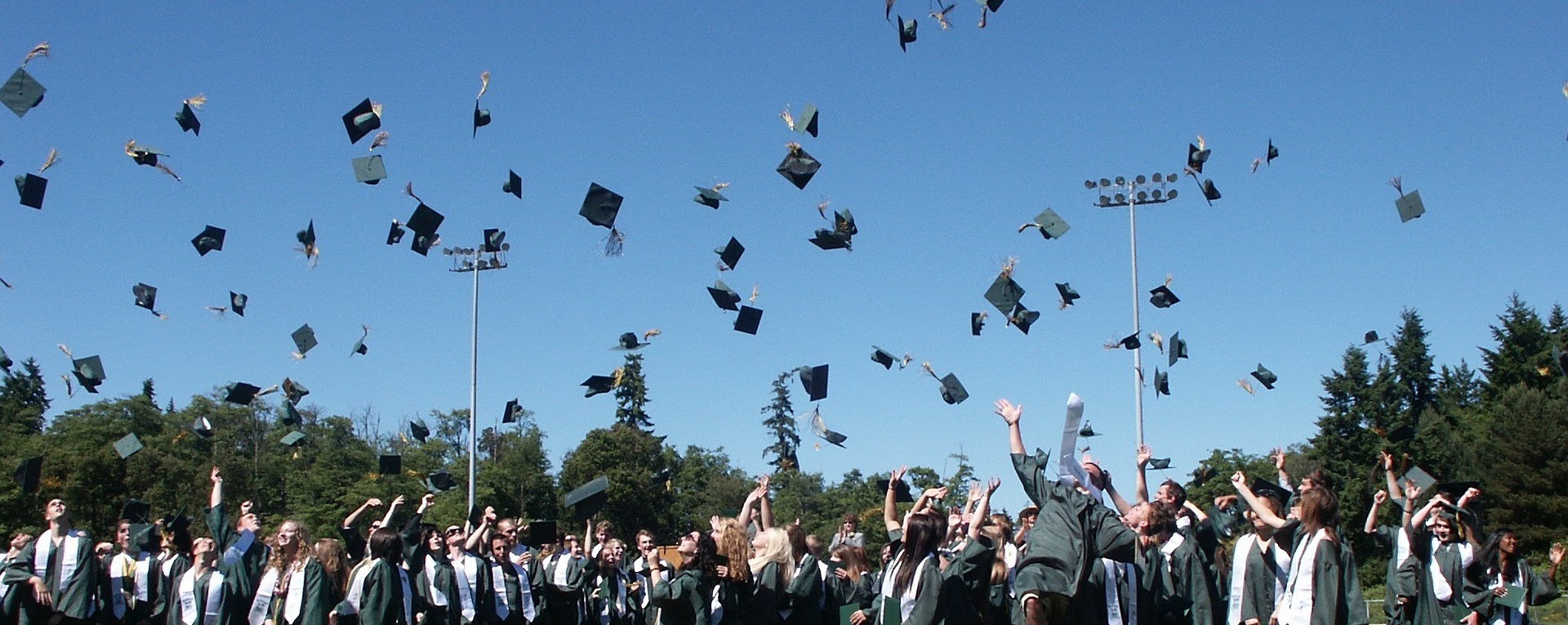 graduates throwing caps