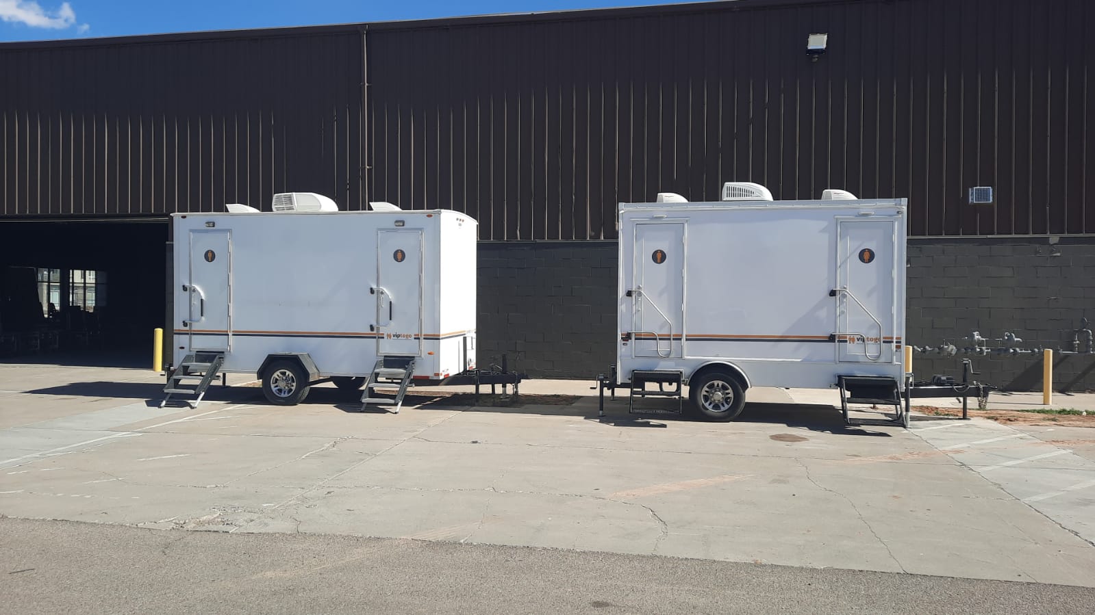 portable toilet trailers parked at a facility