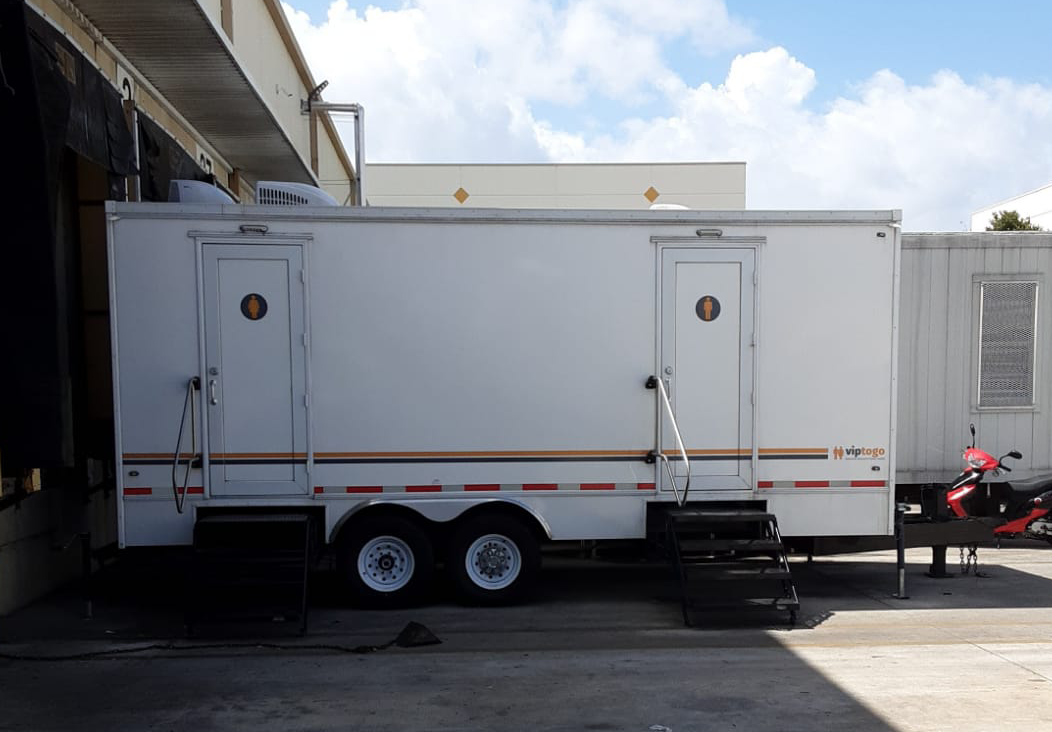 mobile restroom trailer outside building