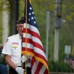 guard holding american flag