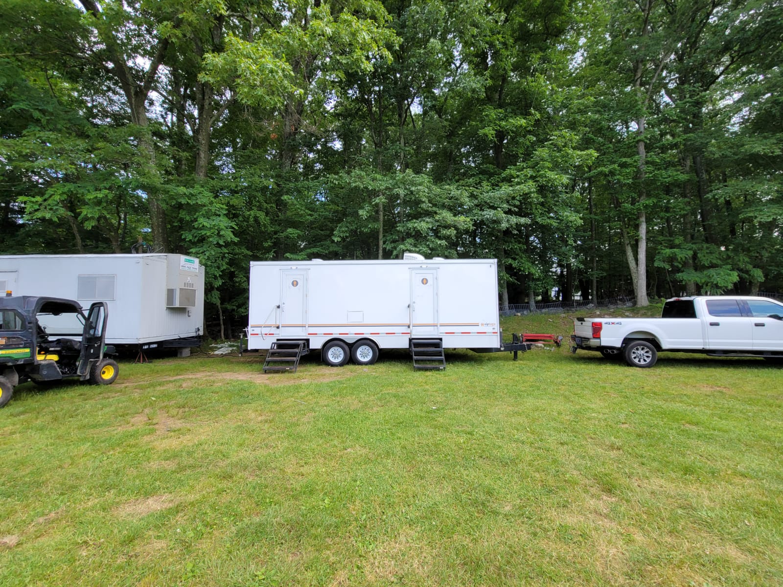 portable restroom trailers on grass