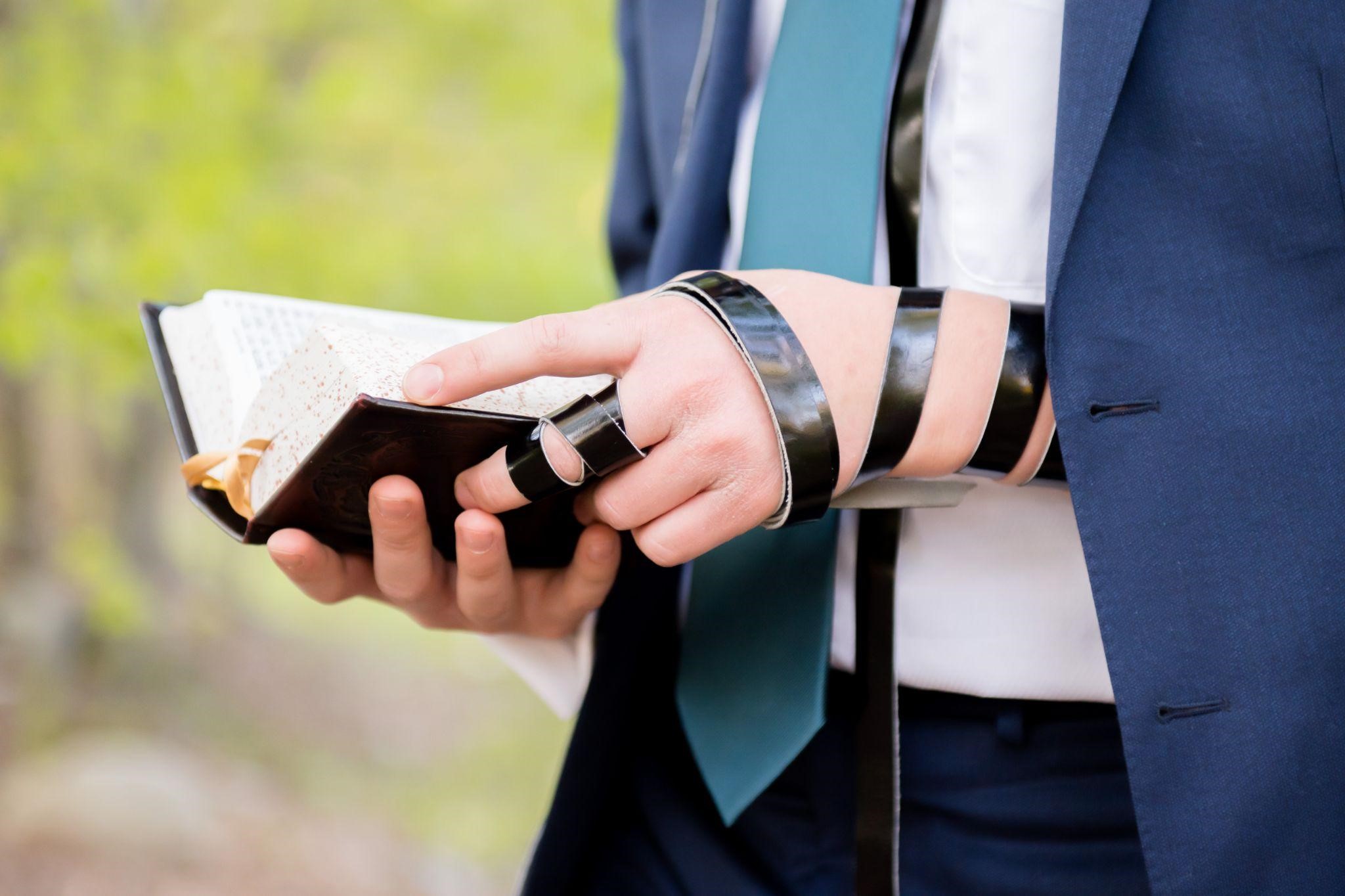 Jewish boy wearing tefillin during prayer