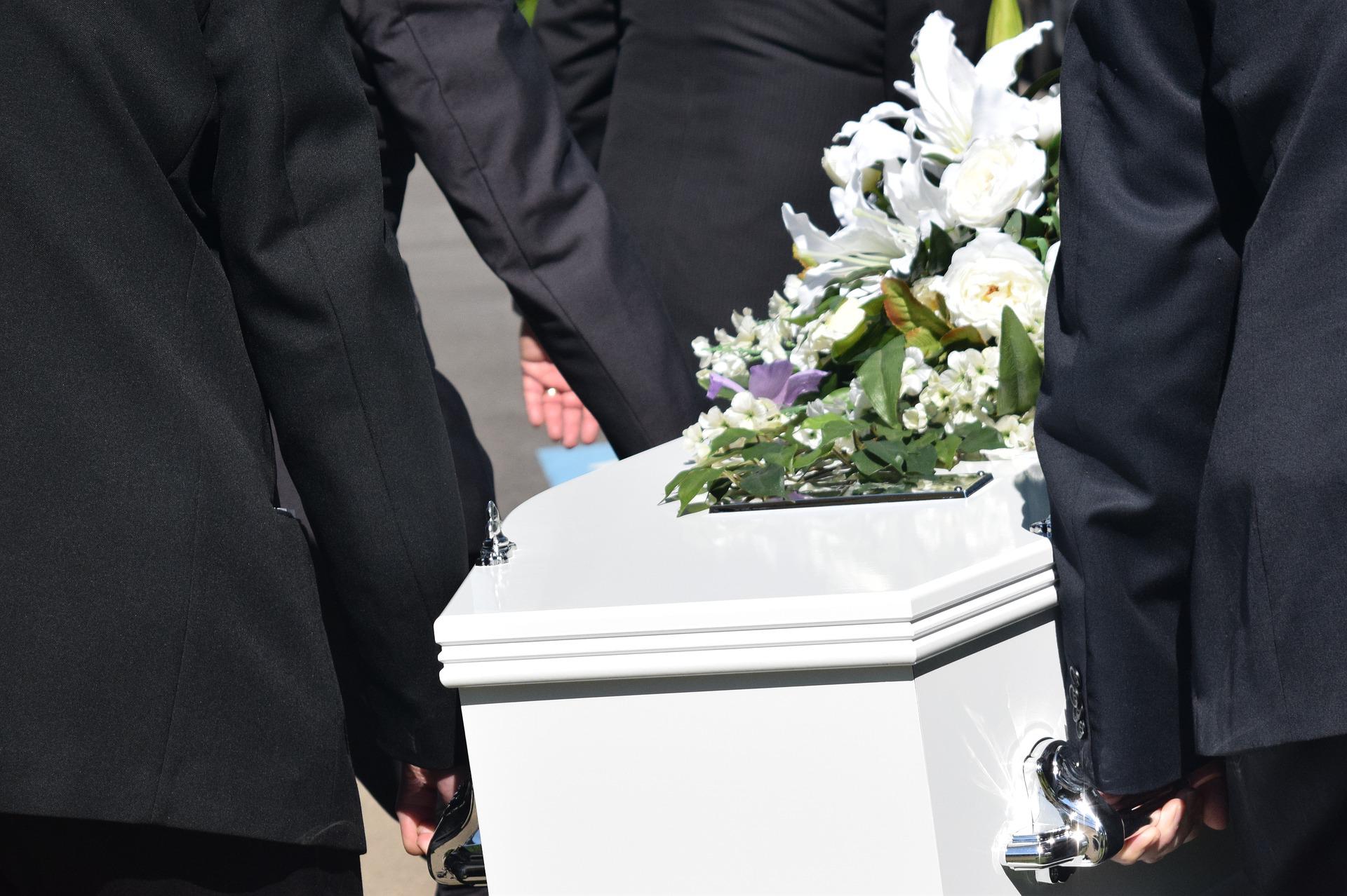 carrying coffin at funeral service