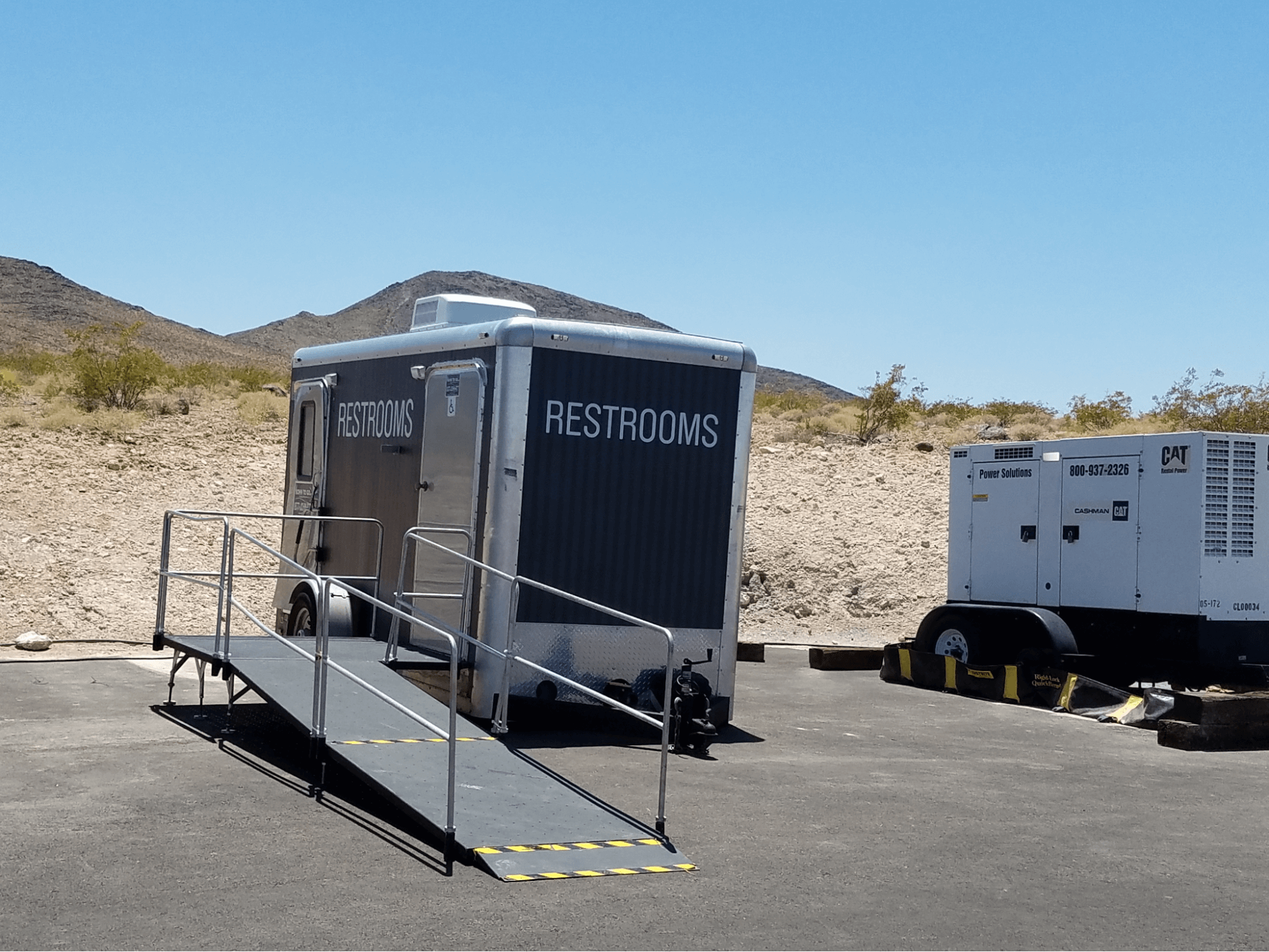 ADA-compliant portable restroom trailer parked outdoors ADA-compliant portable restroom trailer parked outdoors