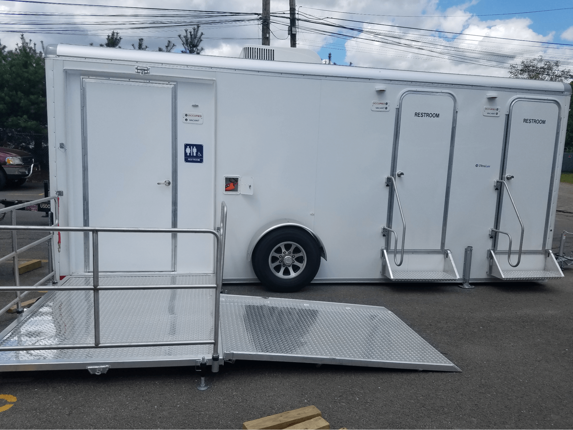 portable ADA-compliant restroom trailer with ramp for easy access