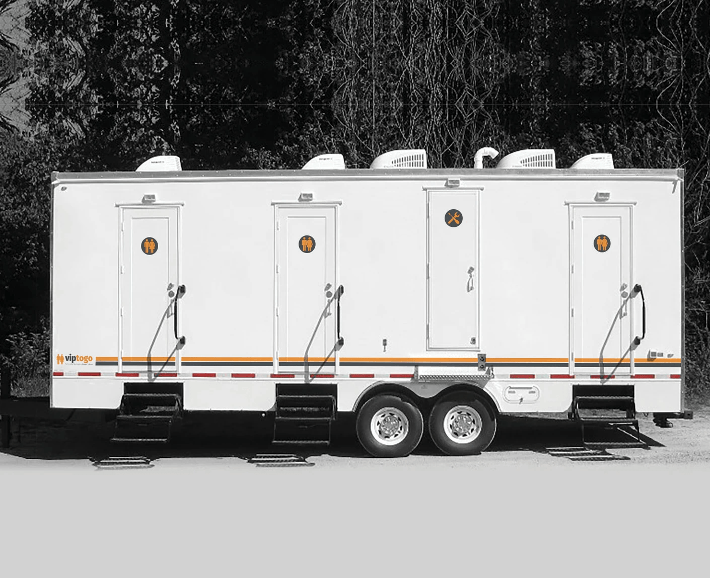 portable shower and restrooms parked at an outdoor spot