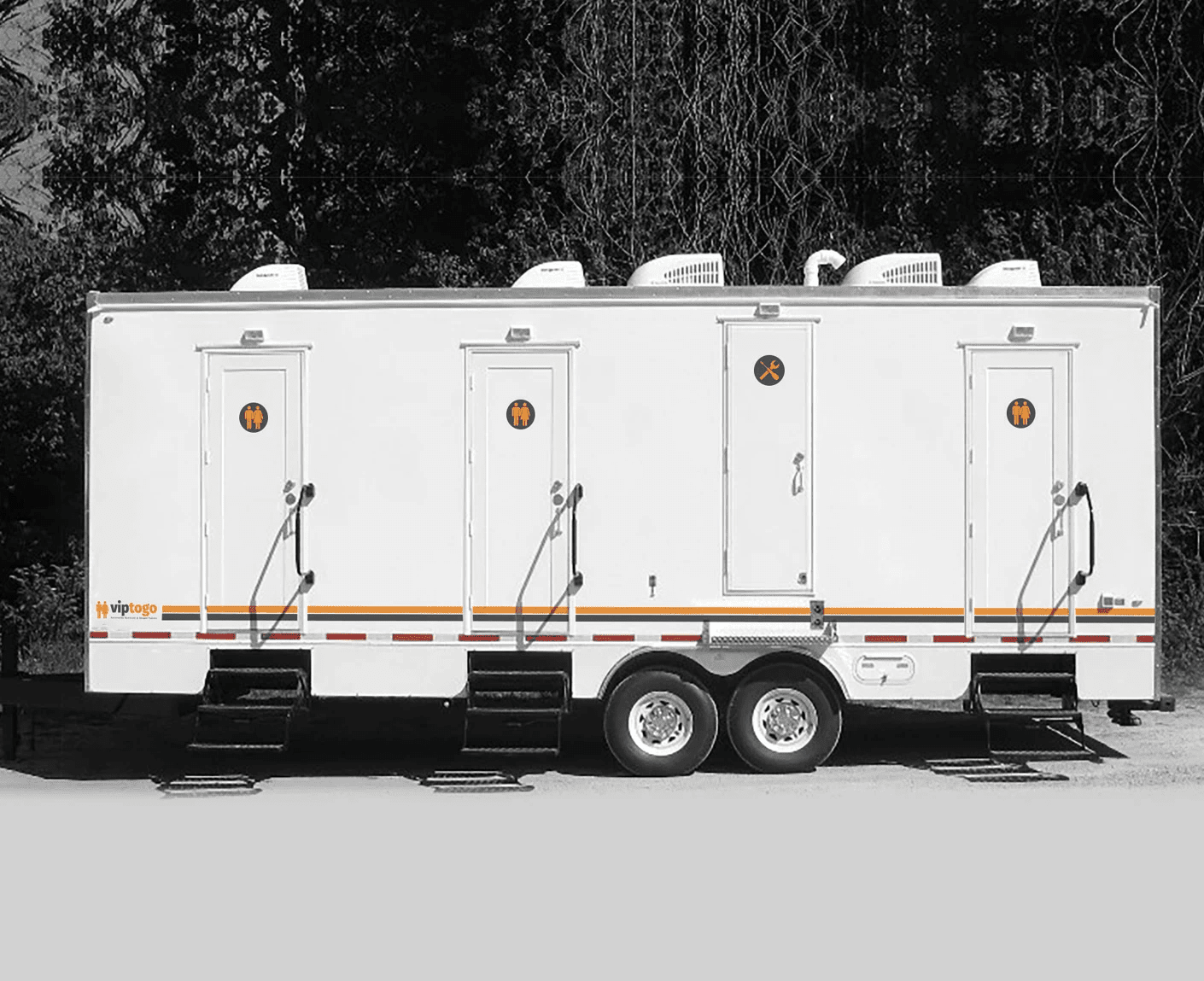 portable shower and restrooms parked at an outdoor spot portable shower and restrooms parked at an outdoor spot
