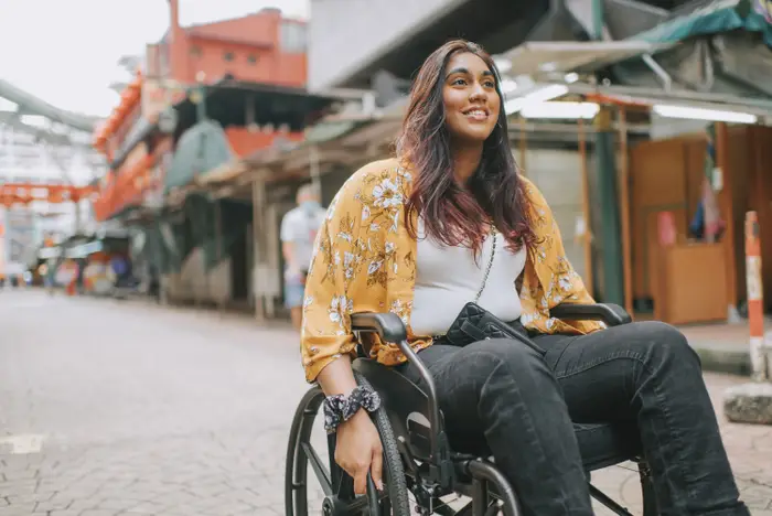 A lady wheeling through a street