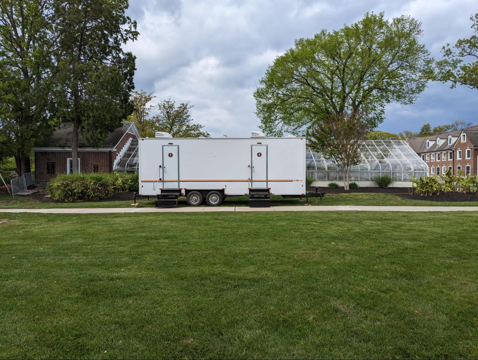 A portable toilet restroom trailer outdoors