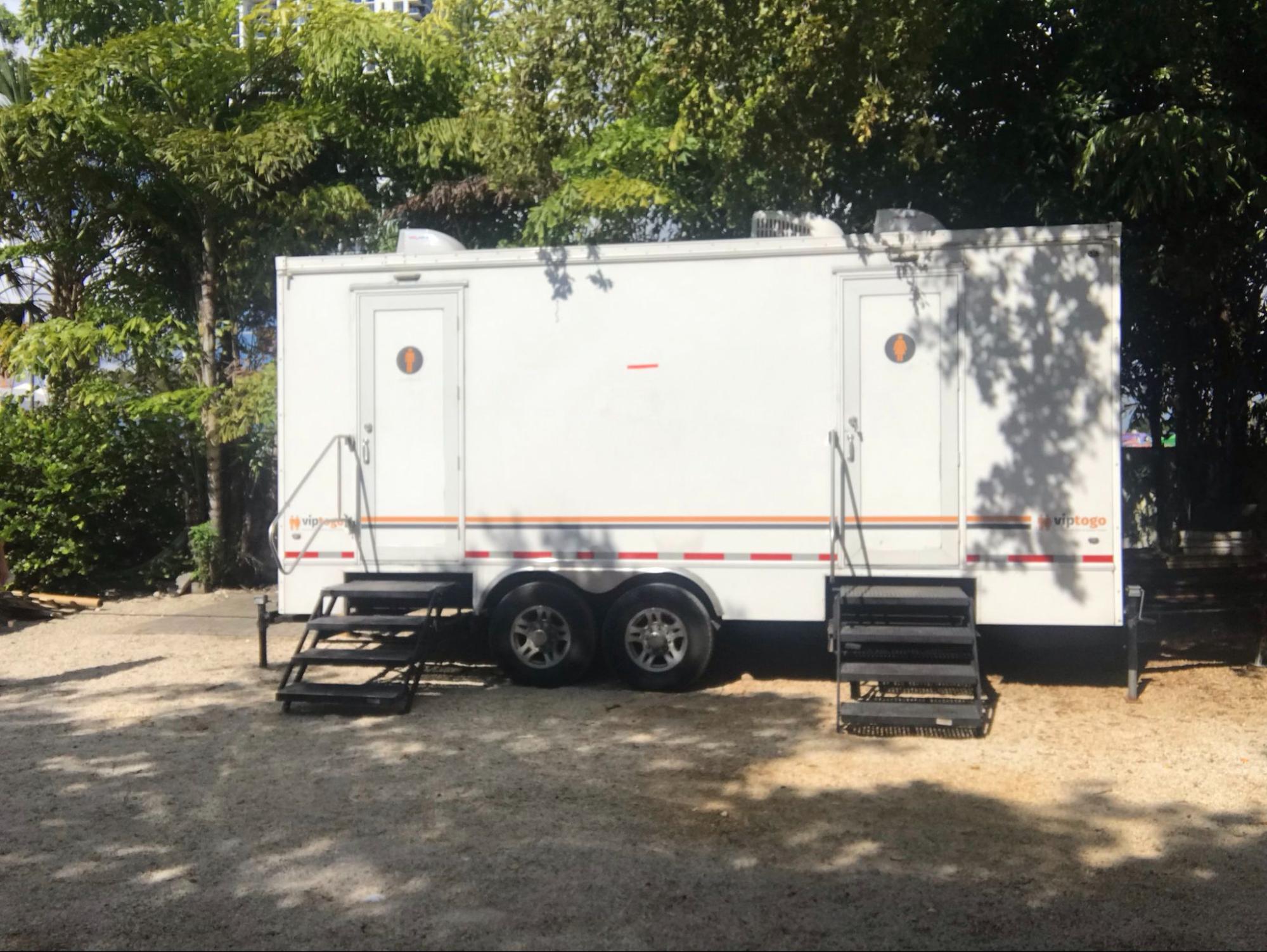 A portable toilet restroom trailer outdoors