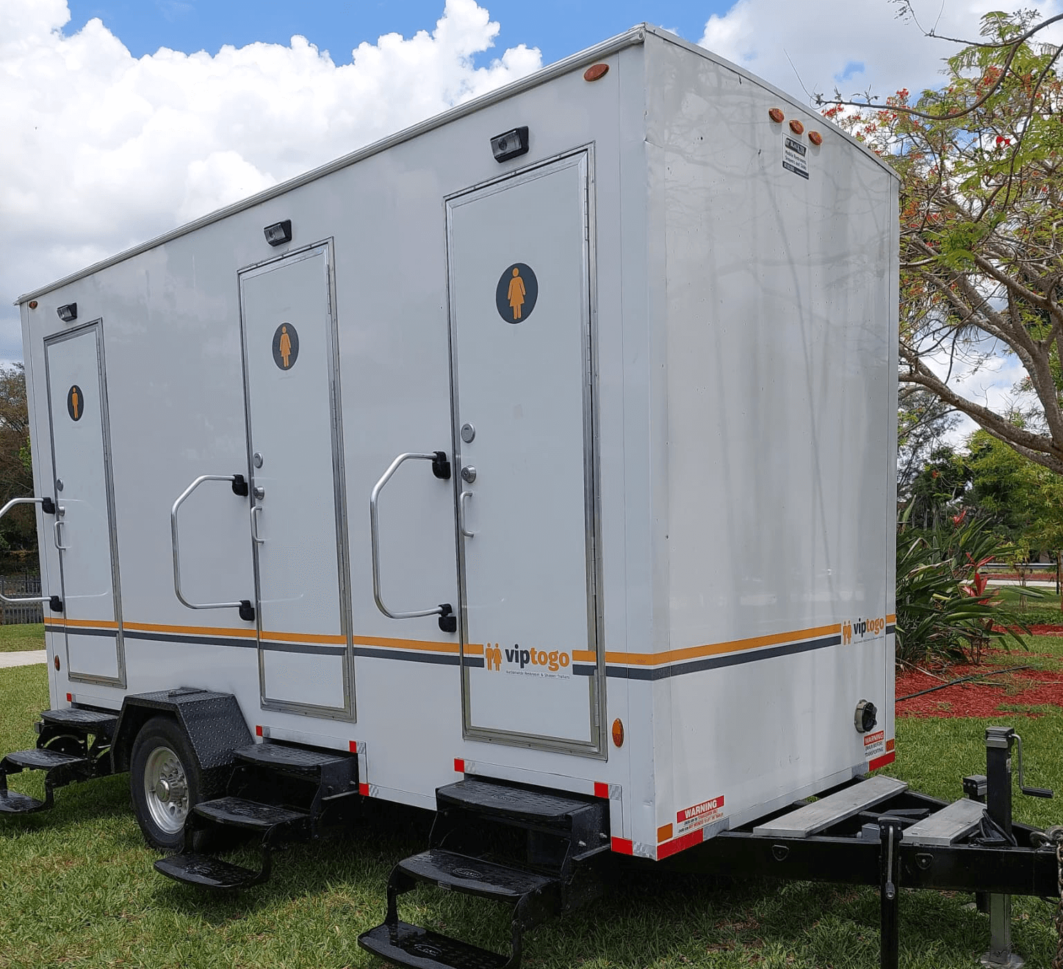 A portable toilet restroom trailer outdoors