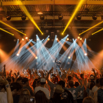 An outdoor music concert with a packed crowd