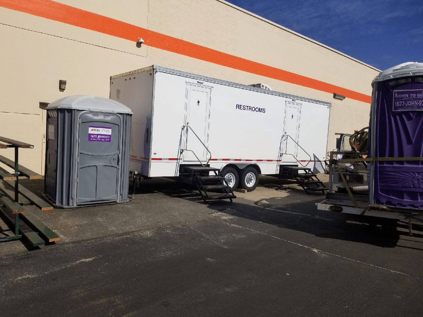 Porta potties and and restroom trailers at an outdoor event